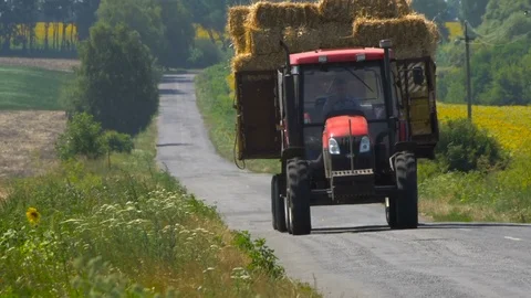 Tractor with straw bales going on the road Stock Footage 69808744
