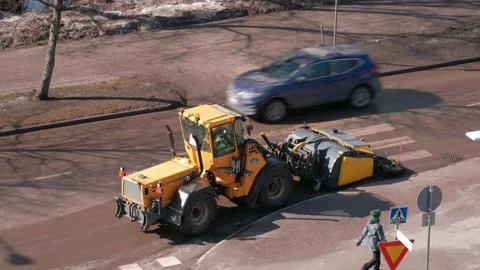 The tractor street sweeper in spring is clearing the street Stock Footage 153623384