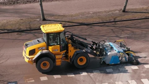 The tractor street sweeper in spring is clearing the street 스톡 동영상 153623579