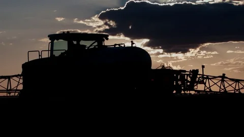 Tractor on sunset background, color correction Stock Footage