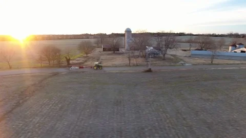 Tractor at sunset on farm drone Stock Footage 123174391