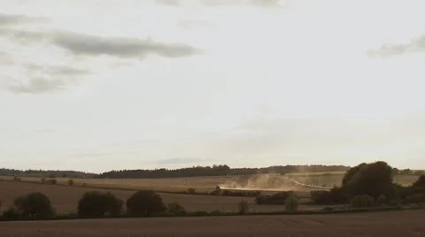 Tractor throwing up dust on farmland Video stock 56058175
