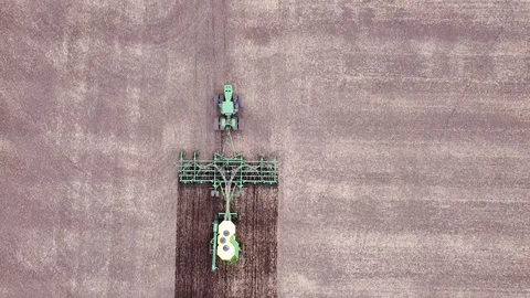 Tractor Tilling and Seeding Field Aerial Stock Footage 129892290