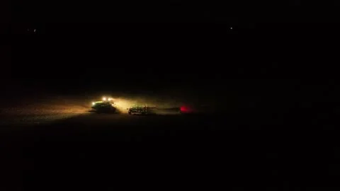 Tractor Tilling soil at night  스톡 동영상 204858851