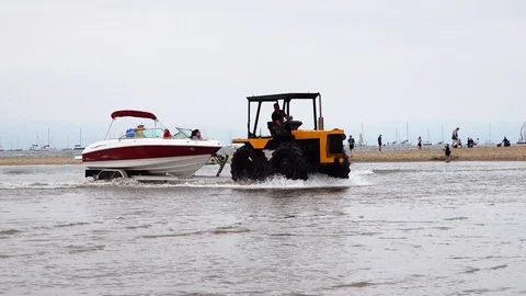 Tractor towing a boat Stock Footage 93018695