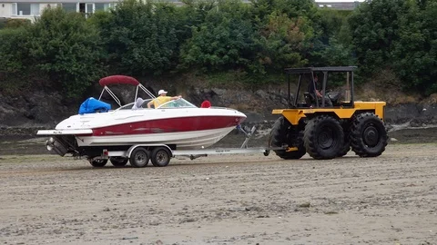 Tractor towing a boat Stock Footage 93019395