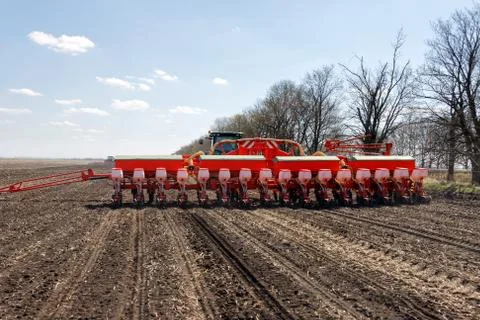 Tractor with trailed planter on the field Stock Photos