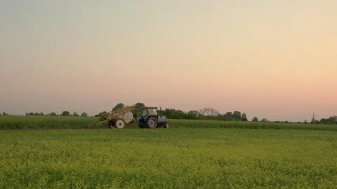 A tractor with a trailed sprayer in the field. Stock Footage 251112123