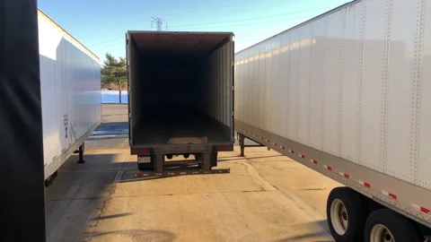 Tractor Trailer Backs in to Loading Dock at Distribution Facility Stock Footage 265906726
