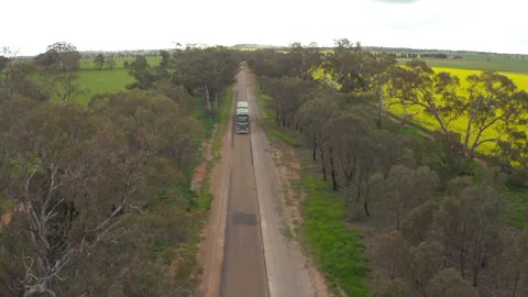 Tractor Trailer Driving Down a Single Lane Country Road Stock Footage 219286011