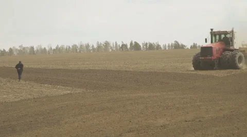 Tractor with trailer storage for grain and seed drill working in field Stock Footage 64619529