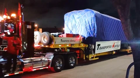 A tractor-trailer is transporting a train car in Bogotá Stock Footage 316834792