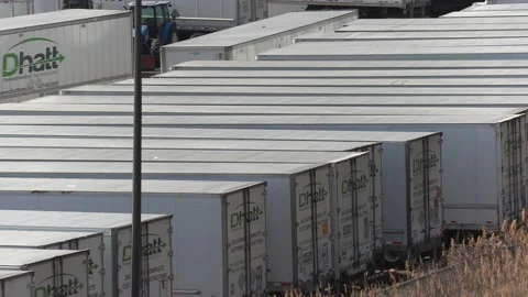 Tractor trailer trucks sit parked during COVID 19 lockdown and recession Vídeo Stock 151663246