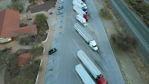 Tractor trailers parked at a rest area off of an interstate highway Stock Footage 170976320