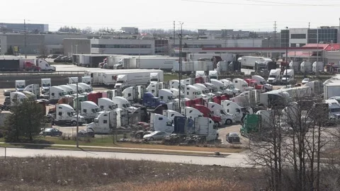 Tractor trailers sit parked during COVID 19 lockdown and economic recession Stock Footage 151664732