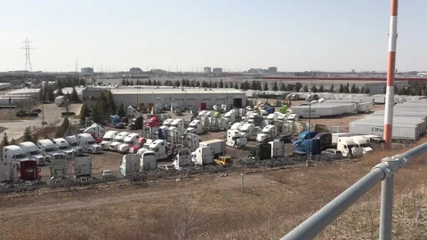 Tractor trailers sit parked during COVID 19 lockdown and economic recession Vidéo 151665409