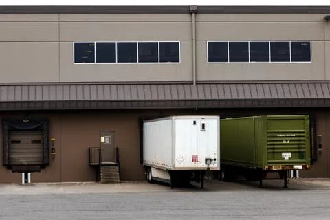 Tractor trailers at a warehouse cargo dock Stock Photos