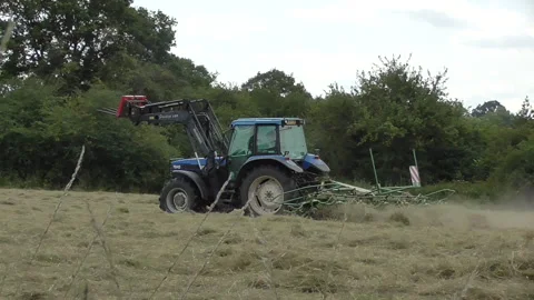 Tractor Trimming a Field of Hay Stock Footage 153808029