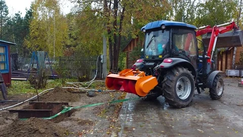 The tractor is trying to pull out a dug-in iron box Stock Footage 196218233