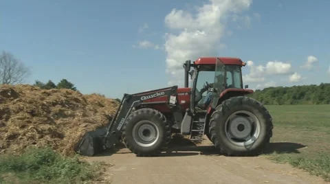 Tractor turning manure pile 01 Stock Footage