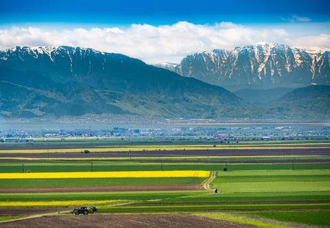 Tractor under the mountains Stock Photos