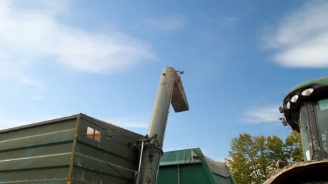 A tractor unloads a corn crop into a grain truck Stock Footage 292501274