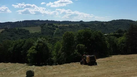 Tractor walks away doing round ballers Stock Footage 144540748