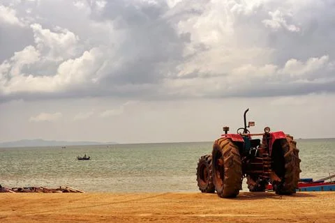 A tractor was parking on an empty beach Stock Photos