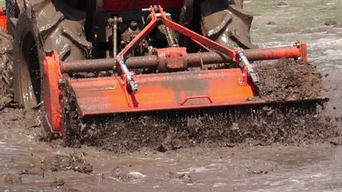 The tractor was working to beat the soil and mix it with water to grow the grain Stock-Footage 146720938