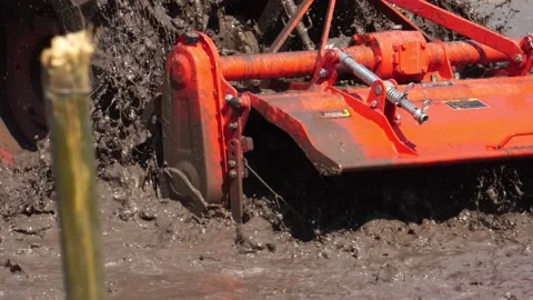 The tractor was working to beat the soil and mix it with water to grow the grain Stock Footage 152716755