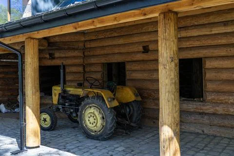 Tractor without a roof, a convertible on a plot near a residential building.. 스톡 사진