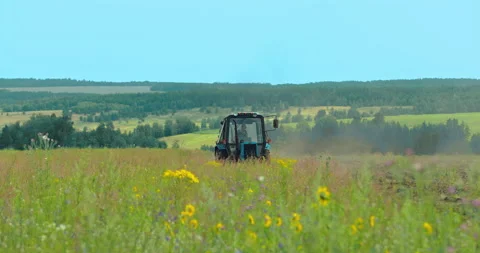 Tractor work in the field, agricultural work. Tractor driver plows the land for Stock Footage 136437249