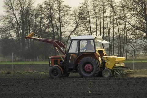 A tractor at work in a field Stock Photos