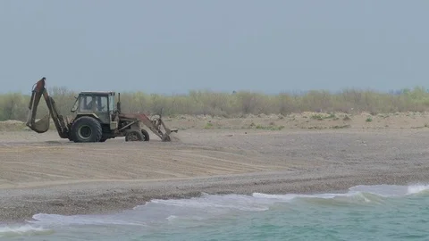 Tractor Working On The Beach Leveling Beach Stock Footage 77495822