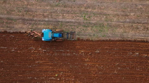 Tractor working diligently in the farmland for effective soil cultivation Stock Footage 321354657