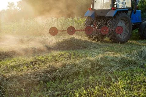 Tractor working on the farm field Stock Photos
