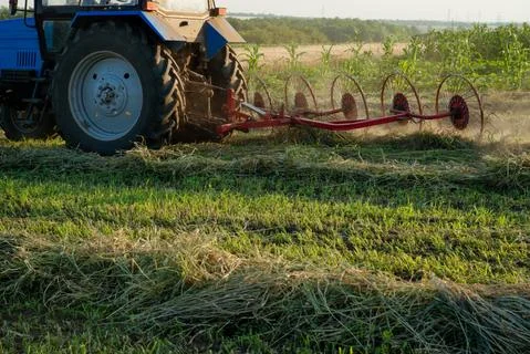 Tractor working on the farm field Stock Photos