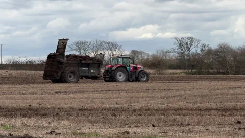 Tractor working on a farm muck spreading Stock-Footage 304504859