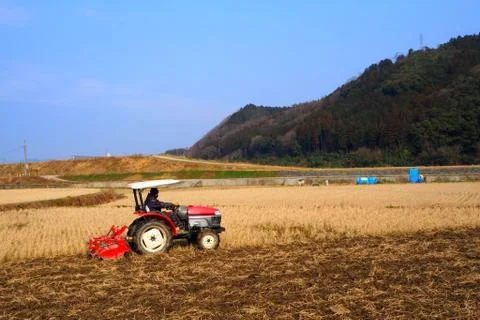 Tractor working on the farm Stock Photos