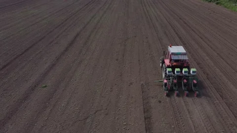 Tractor working in field coming into the frame Stock Footage 158387635