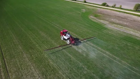 Tractor working in field. Farmer sprays toxic chemicals on farmer's field Stock Footage 279470646