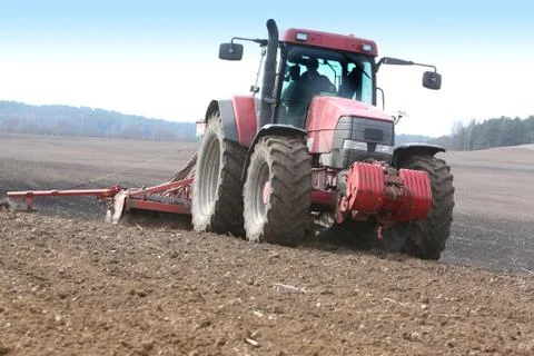 Tractor working on the field Stock Photos