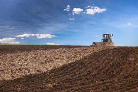 Tractor working on the field Stock Photos