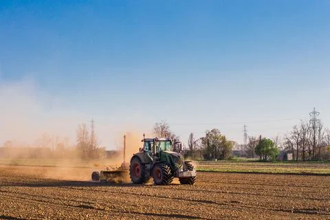 Tractor working in the field, preparing the land for planting Stock Photos