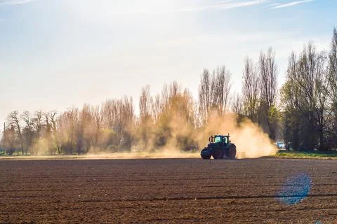 Tractor working in the field, preparing the land for planting Stock Photos