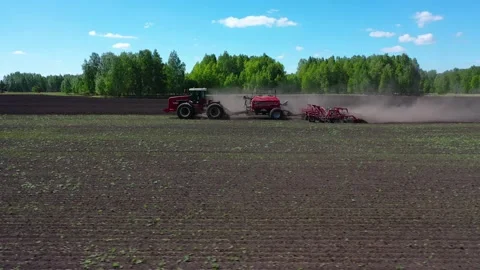 Tractor working in the field, sows grain Stock Footage 130522103