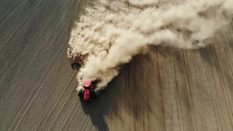 Tractor working in the field, spudding soil with harrow system plowing ground Stock Footage 140033802