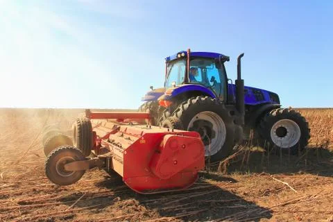 Tractor working in the field. Tractor plow field Agriculture. Stock Photos