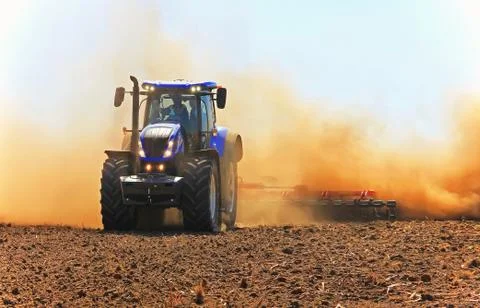 Tractor working in the field. Tractor plow field Agriculture. Stock Photos