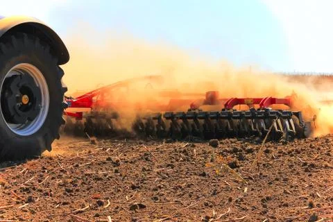Tractor working in the field. Tractor plow field. Agriculture. Cultivated are Stock Photos